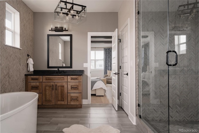 bathroom with a shower stall, a healthy amount of sunlight, and vanity