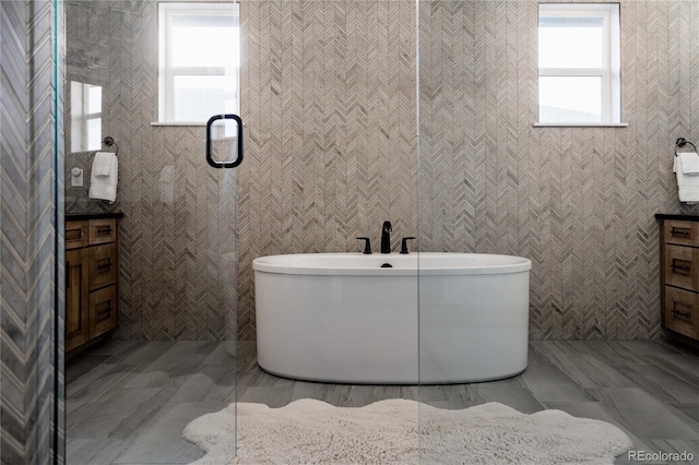 bathroom with a freestanding bath and a healthy amount of sunlight