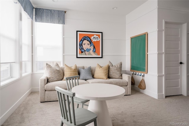living area with baseboards and carpet flooring