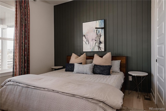 bedroom featuring visible vents and wood finished floors
