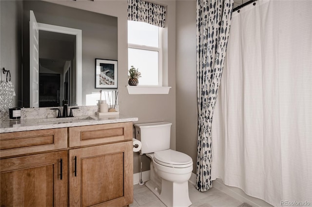 bathroom featuring toilet, tile patterned floors, and vanity