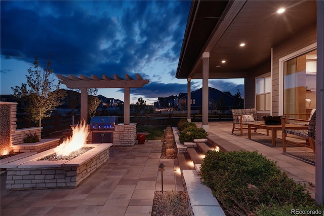 view of patio / terrace with a grill, an outdoor fire pit, and an outdoor kitchen