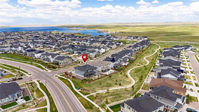 drone / aerial view with a water view and a residential view