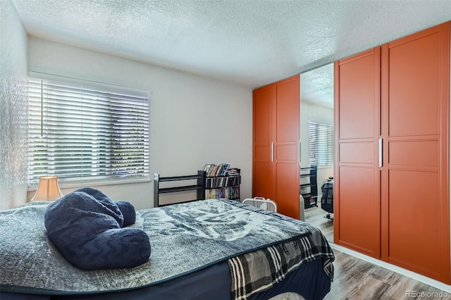 940 S Peoria St, Aurora, CO 80012 - bedroom featuring light wood finished floors and a textured ceiling