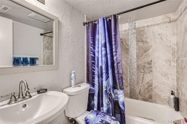 940 S Peoria St, Aurora, CO 80012 - bathroom featuring a sink, a textured wall, shower / bath combo with shower curtain, a textured ceiling, and toilet