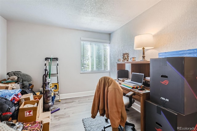 940 S Peoria St, Aurora, CO 80012 - office with a textured ceiling, wood finished floors, a textured wall, and baseboards