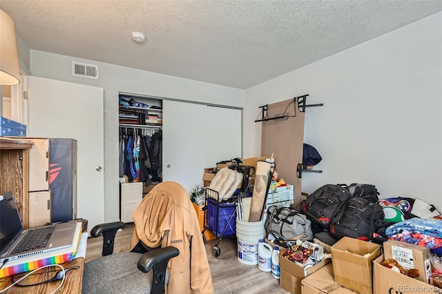 940 S Peoria St, Aurora, CO 80012 - bedroom with wood finished floors, a closet, and a textured ceiling