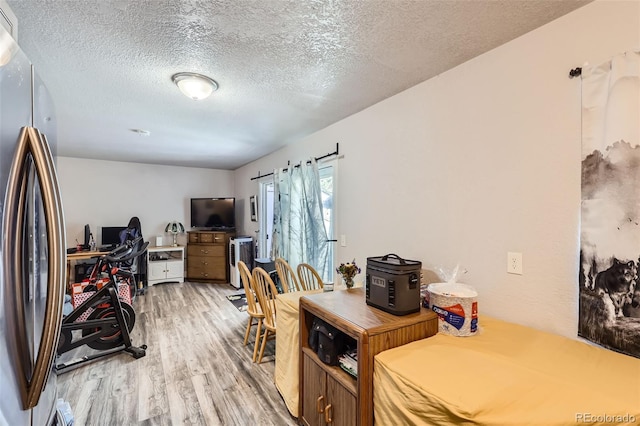 940 S Peoria St, Aurora, CO 80012 - home office with light wood finished floors and a textured ceiling
