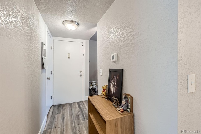 940 S Peoria St, Aurora, CO 80012 - doorway to outside featuring a textured wall, wood finished floors, and a textured ceiling