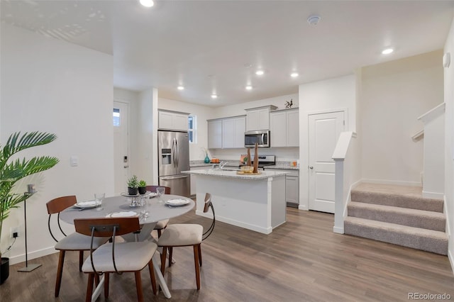7017 Kali Ct, Frederick, CO 80530 - dining area featuring recessed lighting, wood finished floors, and stairway