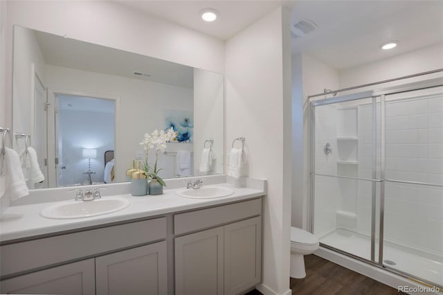 7017 Kali Ct, Frederick, CO 80530 - full bathroom featuring double vanity, a shower stall, and wood finished floors
