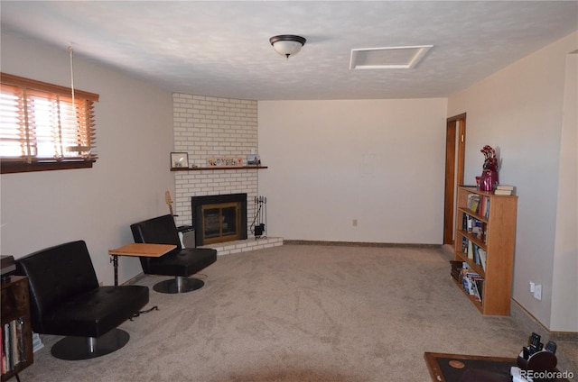 living area with a textured ceiling, carpet floors, a fireplace, and baseboards