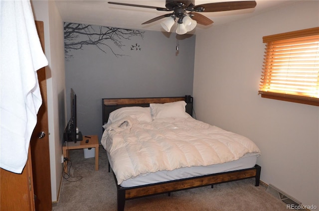 bedroom featuring carpet floors, ceiling fan, visible vents, and baseboards