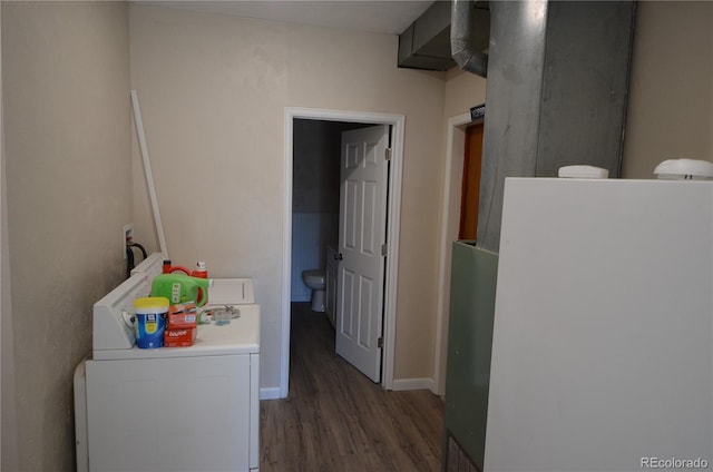 laundry room featuring laundry area, wood finished floors, washer / dryer, and baseboards