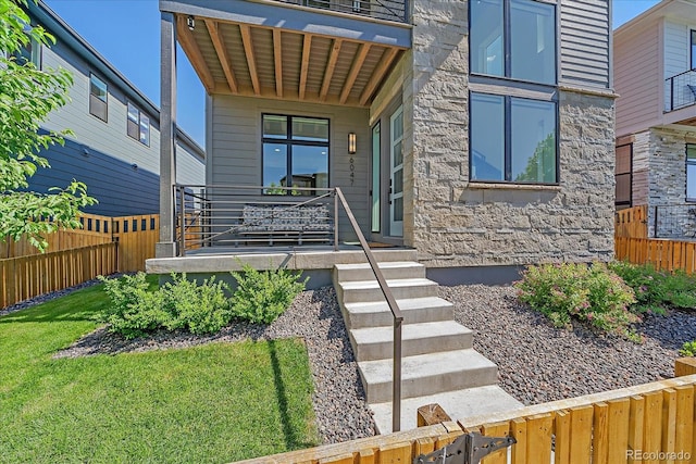 6047 N Nepal Ct, Aurora, CO 80019 - entrance to property featuring stone siding and covered porch