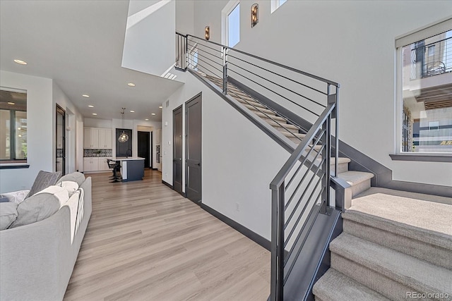 6047 N Nepal Ct, Aurora, CO 80019 - stairs featuring wood finished floors and recessed lighting