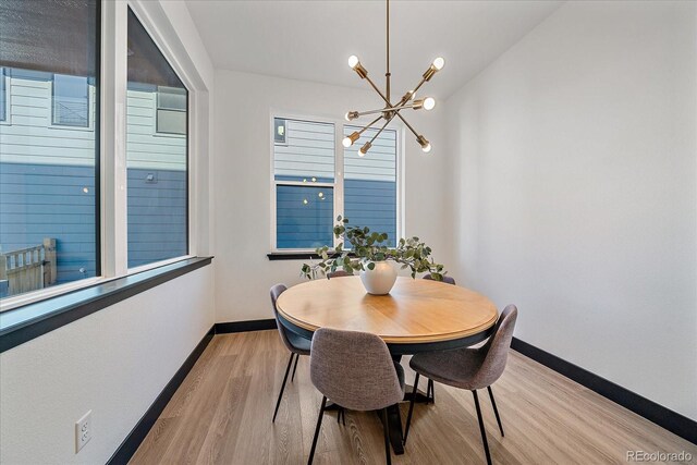 6047 N Nepal Ct, Aurora, CO 80019 - dining room featuring a chandelier and light wood finished floors