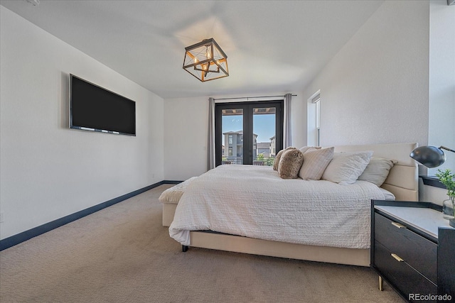 6047 N Nepal Ct, Aurora, CO 80019 - bedroom featuring light carpet, a chandelier, and access to outside