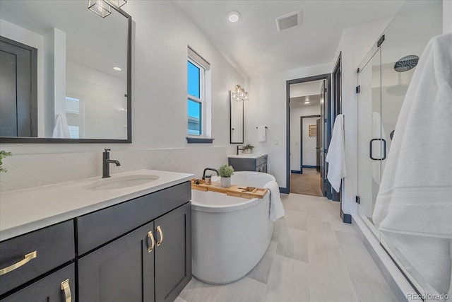 6047 N Nepal Ct, Aurora, CO 80019 - full bath featuring a shower stall, two vanities, and a freestanding tub