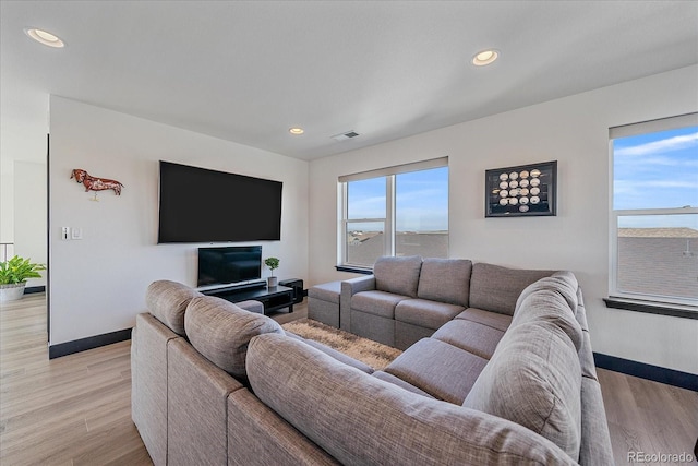 6047 N Nepal Ct, Aurora, CO 80019 - living area with light wood-type flooring and recessed lighting