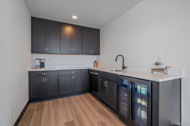 6047 N Nepal Ct, Aurora, CO 80019 - kitchen with dishwashing machine, beverage cooler, light wood-type flooring, light countertops, and recessed lighting