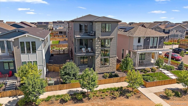 6047 N Nepal Ct, Aurora, CO 80019 - contemporary home featuring a residential view and stone siding