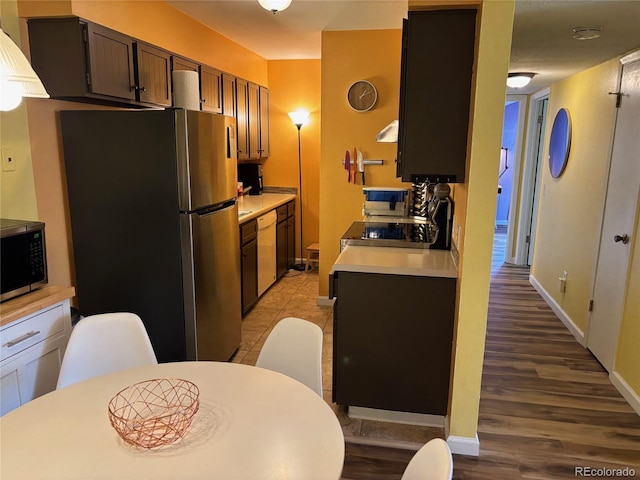 kitchen with dark brown cabinets and stainless steel appliances