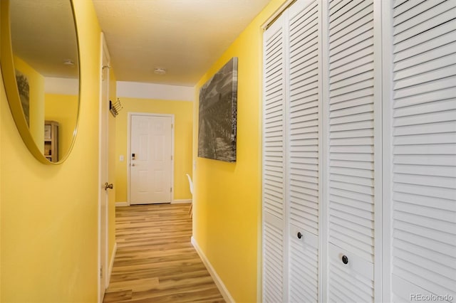 corridor with light hardwood / wood-style flooring