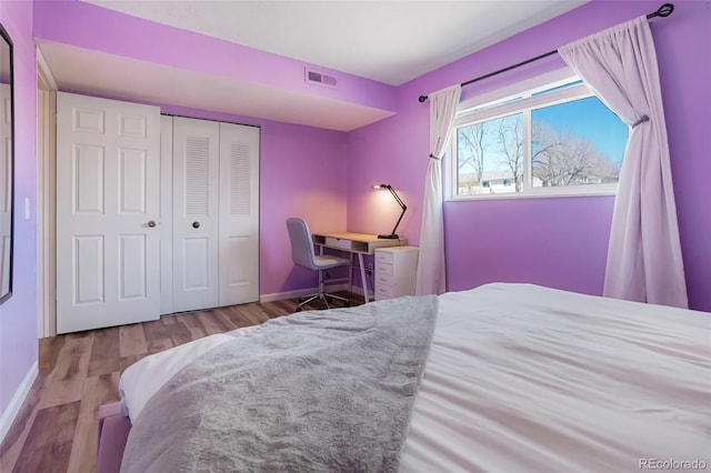 bedroom featuring light hardwood / wood-style flooring and a closet