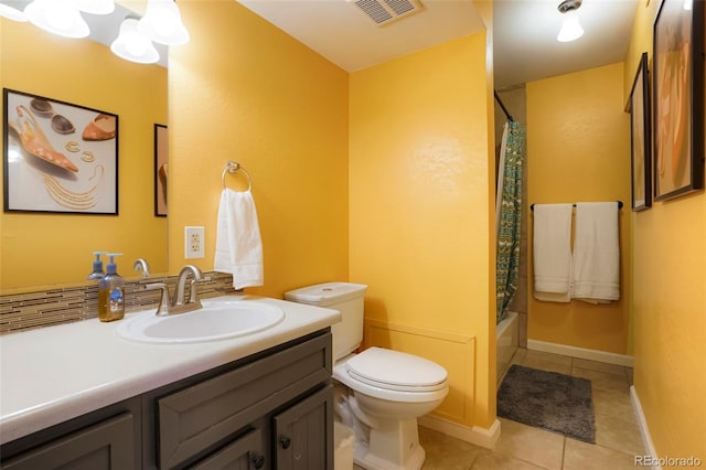 full bathroom with tile patterned flooring, shower / bath combo, vanity, and toilet