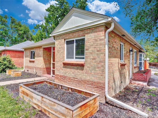 1600 Xanthia St, Denver, CO 80220 - view of front facade featuring a garden and brick siding