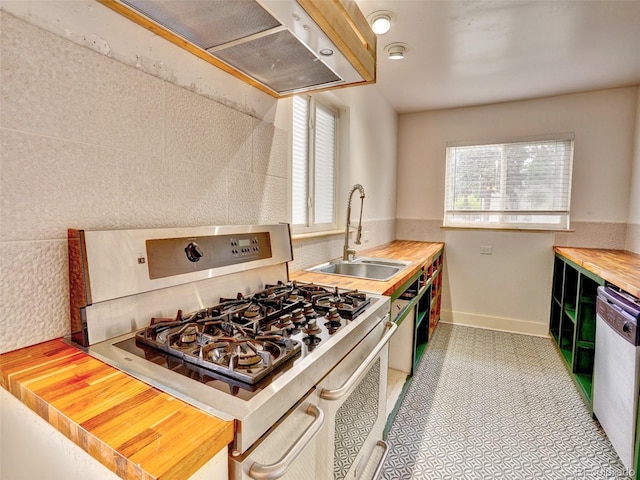 1600 Xanthia St, Denver, CO 80220 - kitchen with white gas range oven, a sink, dishwasher, butcher block counters, and ventilation hood