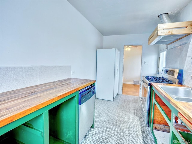 1600 Xanthia St, Denver, CO 80220 - kitchen featuring white appliances, butcher block counters, and extractor fan