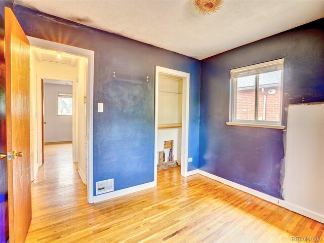 1600 Xanthia St, Denver, CO 80220 - unfurnished room with wood finished floors, attic access, and baseboards