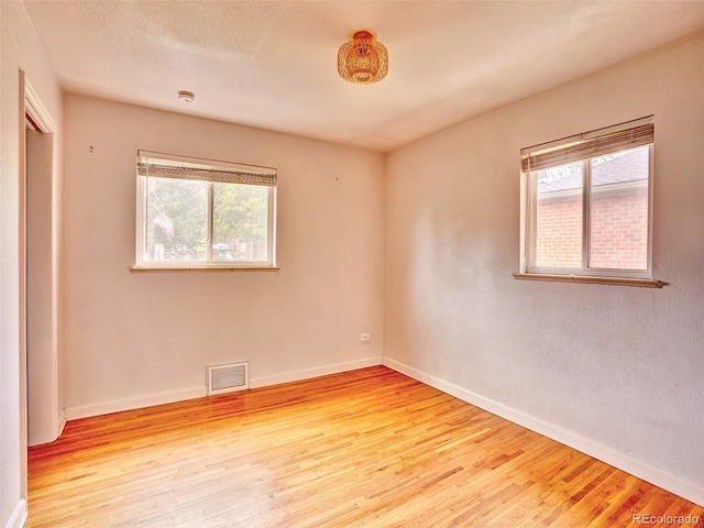 1600 Xanthia St, Denver, CO 80220 - spare room with healthy amount of natural light, wood finished floors, and baseboards
