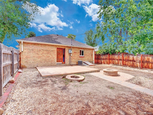 1600 Xanthia St, Denver, CO 80220 - rear view of house featuring an outdoor fire pit, a patio, brick siding, and a fenced backyard