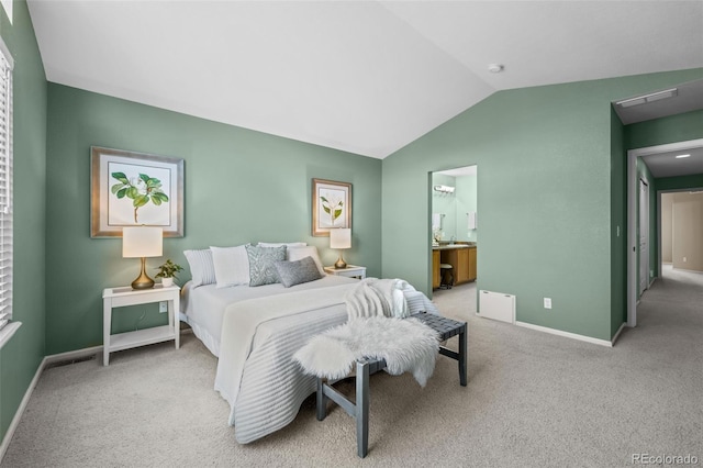 bedroom with visible vents, connected bathroom, carpet floors, baseboards, and vaulted ceiling