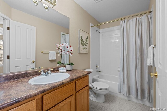 bathroom with vanity, shower / bath combination with curtain, and toilet