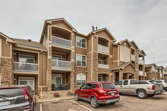 view of building exterior featuring uncovered parking