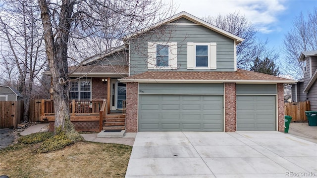 view of front of house with brick siding, fence, and driveway