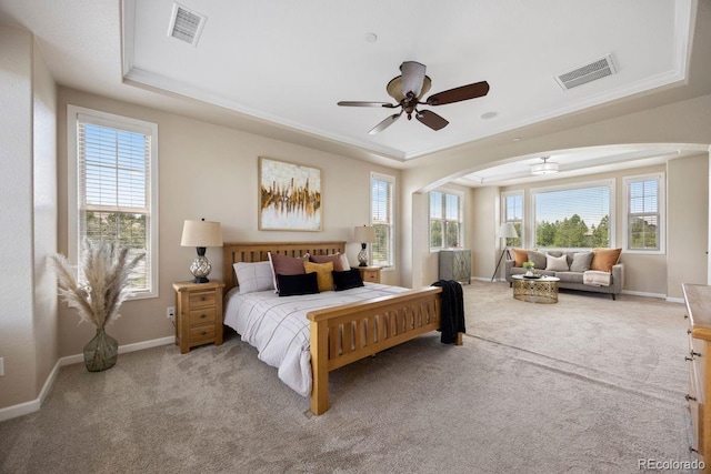 6299 Ellingwood Point Pl, Castle Rock, CO 80108 - carpeted bedroom featuring a raised ceiling, arched walkways, and a ceiling fan
