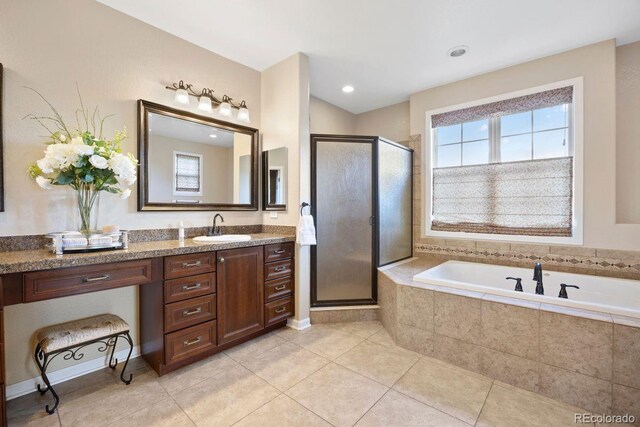 6299 Ellingwood Point Pl, Castle Rock, CO 80108 - bathroom with vanity, a stall shower, a garden tub, and tile patterned floors