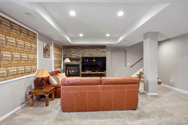 6299 Ellingwood Point Pl, Castle Rock, CO 80108 - living room featuring light colored carpet, a raised ceiling, stairway, a fireplace, and recessed lighting