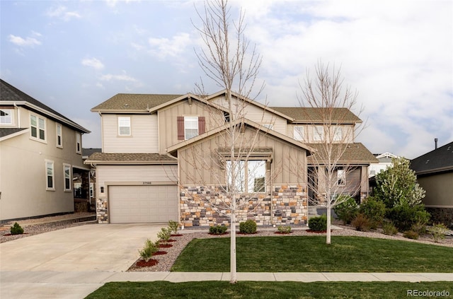 craftsman-style house featuring board and batten siding, a garage, a front lawn, concrete driveway, and stone siding