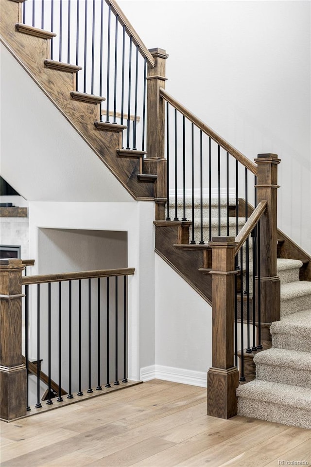 stairway featuring baseboards and wood finished floors