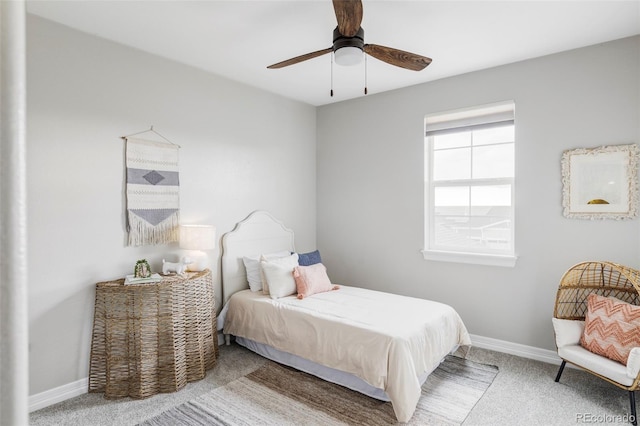 carpeted bedroom with baseboards and a ceiling fan
