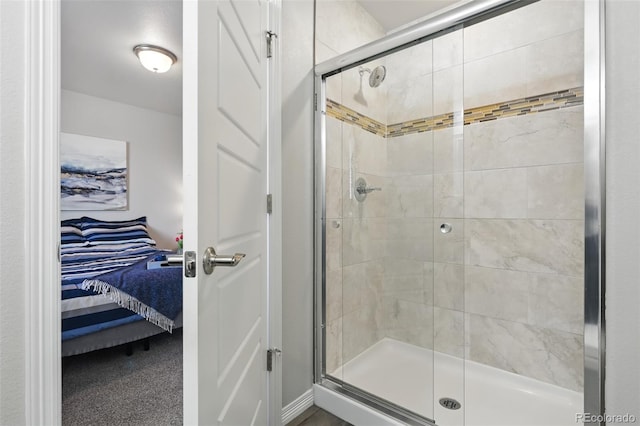 ensuite bathroom featuring ensuite bathroom and a stall shower