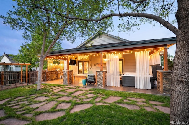 6480 Moss Cir, Arvada, CO 80007 - back of house featuring a hot tub, a patio, and exterior kitchen