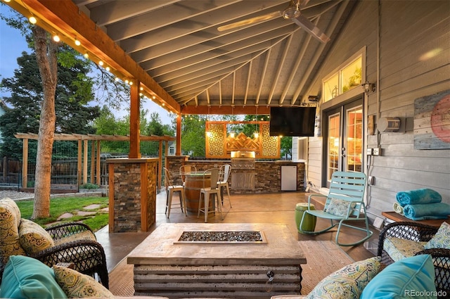 6480 Moss Cir, Arvada, CO 80007 - view of patio / terrace with french doors, an outdoor living space with a fire pit, an outdoor kitchen, and an outdoor bar