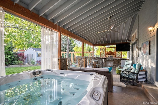 6480 Moss Cir, Arvada, CO 80007 - view of patio with an outdoor kitchen, a hot tub, a ceiling fan, and an outdoor hangout area